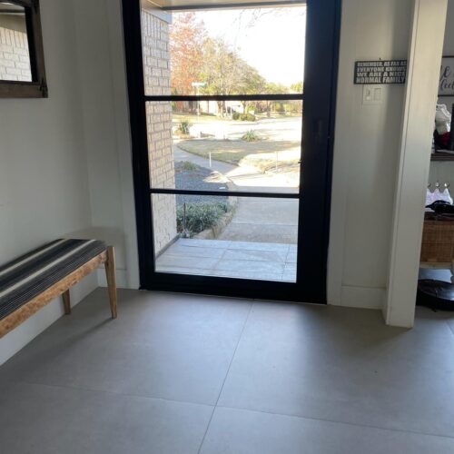 Modern custom black iron door with clear glass panels – interior view